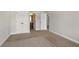 Bedroom featuring carpeting, neutral paint and doors to closets and bathrooms at 829 Overlook Path Ln, Lawrenceville, GA 30045