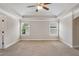 Spacious bedroom with a tray ceiling, ceiling fan, neutral carpet, and two bright windows at 829 Overlook Path Ln, Lawrenceville, GA 30045