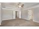 Large bedroom featuring neutral carpet, closet doors, and a view of a connecting room at 829 Overlook Path Ln, Lawrenceville, GA 30045