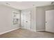 Carpeted bedroom with neutral walls, bright window, and closet with double doors at 829 Overlook Path Ln, Lawrenceville, GA 30045