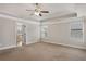 Large bedroom featuring neutral carpet, a tray ceiling, a ceiling fan, and bright windows at 829 Overlook Path Ln, Lawrenceville, GA 30045