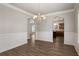 Dining room view showcasing molding and dark wood floors at 829 Overlook Path Ln, Lawrenceville, GA 30045