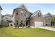 Beautiful brick home with lush green lawn, an attached two-car garage, and manicured landscaping at 829 Overlook Path Ln, Lawrenceville, GA 30045