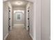 Hallway with arch and doorways leading to carpeted rooms at 829 Overlook Path Ln, Lawrenceville, GA 30045