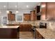 Kitchen view featuring stainless appliances, granite countertops, tile backsplash, wood floors and pendant lighting at 829 Overlook Path Ln, Lawrenceville, GA 30045