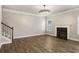 Spacious living room with dark wood floors, a fireplace, and a stunning chandelier at 829 Overlook Path Ln, Lawrenceville, GA 30045