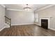 Living room features wood floors, a fireplace, decorative lighting, and a staircase at 829 Overlook Path Ln, Lawrenceville, GA 30045