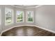 Bright interior features three large windows, fresh paint, and sleek, dark wood flooring at 829 Overlook Path Ln, Lawrenceville, GA 30045