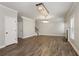 Living room showcasing wood floors, modern lighting, a fireplace, and stairs to the second floor at 829 Overlook Path Ln, Lawrenceville, GA 30045