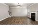 Spacious living room features wood floors, fireplace, stairs to the second floor and a modern chandelier at 829 Overlook Path Ln, Lawrenceville, GA 30045