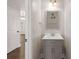 Elegant powder room featuring a grey vanity with a white countertop and stylish mirror at 829 Overlook Path Ln, Lawrenceville, GA 30045