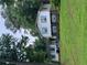 Charming home featuring white siding, blue shutters, and lush green lawn surrounded by mature trees at 2505 King Louis Rd, Conyers, GA 30012