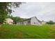 Side view of a house, showcasing its backyard and the surrounding greenery at 275 Green Commons Dr, Covington, GA 30016