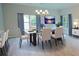 Dining room with a modern glass table, chandelier, and luxury vinyl plank flooring at 275 Green Commons Dr, Covington, GA 30016