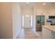 Open entryway with white door, luxury vinyl plank flooring, stainless steel appliances at 275 Green Commons Dr, Covington, GA 30016