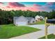 A charming home with gray siding, lush green lawn, and manicured landscaping at 275 Green Commons Dr, Covington, GA 30016