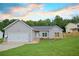 Charming single-story home with a well-manicured lawn, and attached two-car garage at 275 Green Commons Dr, Covington, GA 30016