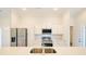 Modern kitchen with stainless steel appliances, white cabinets, and granite countertops for a sleek look at 275 Green Commons Dr, Covington, GA 30016