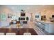 Open-concept living room boasts a stone fireplace and hardwood floors adjacent to the modern kitchen at 275 Green Commons Dr, Covington, GA 30016