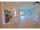 Open-concept living space with kitchen island and luxury vinyl plank flooring at 275 Green Commons Dr, Covington, GA 30016