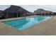 Community pool featuring a splash pad, lounge area and clubhouse with lush landscaping and room for many residents at 403 Sonja Ln, Loganville, GA 30052