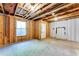 Unfinished basement featuring framed walls, a window, and an entry door at 992 Belfry Ter, Fairburn, GA 30213