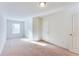 Bright bedroom with carpet, a window, and white walls provides a modern, clean, and serene living space at 992 Belfry Ter, Fairburn, GA 30213