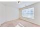 Bright bedroom with carpet flooring and natural light streaming in through a large window at 992 Belfry Ter, Fairburn, GA 30213