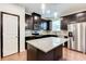 Modern kitchen featuring stainless steel appliances, dark wood cabinetry, and granite countertops at 992 Belfry Ter, Fairburn, GA 30213