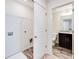 Conveniently located laundry room adjacent to a half-bathroom with wood-look flooring at 992 Belfry Ter, Fairburn, GA 30213
