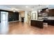 Open concept living space with hardwood floors, a fireplace, and views of a modern kitchen at 992 Belfry Ter, Fairburn, GA 30213