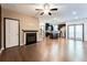 Open-concept living area with fireplace, hardwood floors, and view of the kitchen at 992 Belfry Ter, Fairburn, GA 30213