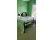 Cozy bedroom with twin beds, natural light, and green walls at 999 Simonton Glen Dr, Lawrenceville, GA 30045