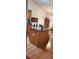 Kitchen featuring a granite countertop island with display cases and warm-toned wood floors at 999 Simonton Glen Dr, Lawrenceville, GA 30045