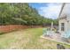 Private backyard featuring a patio with a dining set, lush greenery, and mature trees for shade and enjoyment at , Loganville, GA 30052