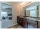 Bright bathroom featuring double sinks, granite countertop, and a view of the bedroom at , Loganville, GA 30052