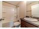 Clean bathroom featuring a shower-tub combo and a modern vanity with solid surface countertops at , Loganville, GA 30052