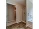 Bathroom featuring a tub with shower and glass enclosure, tiled floors and access to closet at , Loganville, GA 30052