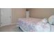Bedroom with a patterned bedspread and a view of a white door, offering a simple and calming space at , Loganville, GA 30052