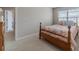 Bright bedroom with carpet, a wooden bedframe, and a dresser visible from the doorway at , Loganville, GA 30052
