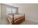 Simple bedroom with neutral walls, a floral bedspread, and a bright window at , Loganville, GA 30052