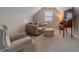 Cozy sitting area featuring natural light, neutral decor, and plush seating at , Loganville, GA 30052