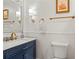 Elegant bathroom features a marble countertop, gold hardware, and wainscotting at 1429 Noel Ne Dr, Brookhaven, GA 30319