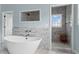 This bathroom has a soaking tub and tiled walk-in shower with glass enclosure at 1429 Noel Ne Dr, Brookhaven, GA 30319