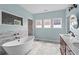 The bathroom features a soaking tub, marble tile and a double vanity at 1429 Noel Ne Dr, Brookhaven, GA 30319