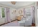 Charming Bedroom with large windows, soft rug and comfortable glider at 1429 Noel Ne Dr, Brookhaven, GA 30319