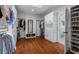 This walk-in closet has custom shelving, shoe storage, and hardwood floors at 1429 Noel Ne Dr, Brookhaven, GA 30319