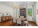 Bright dining room featuring a wooden table with seating for six, complemented by stylish lighting and elegant decor at 1429 Noel Ne Dr, Brookhaven, GA 30319