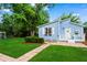 Charming light blue home with a well-manicured lawn and lush landscaping at 1429 Noel Ne Dr, Brookhaven, GA 30319
