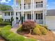 Inviting home featuring a charming porch, complemented by lush landscaping and stone pathway, creating a welcoming entrance at 1429 Noel Ne Dr, Brookhaven, GA 30319